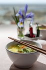 From above oriental ramen healthy noodles soup with shiitake, spinach, carrots, eggs and chillies on restaurant table — Stock Photo
