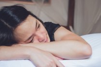 Ottimista premurosa donna asiatica distesa distesa su un comodo letto al mattino a casa — Foto stock