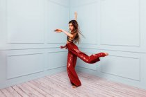 Stylish dancer jumping in corner of studio — Stock Photo