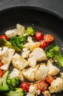 Tomatoes frying with cauliflower and broccoli — Stock Photo
