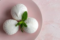 From above top view of homemade white Zefir traditional russian dessert with mint on pink background — Stock Photo