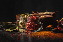 From above composition with different kinds of natural aromatic spices placed on slate surface background — Stock Photo