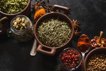 Top view composition with different kinds of natural aromatic spices placed on slate surface background — Stock Photo