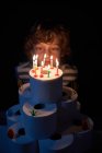 Blond boy blowing out the candles on his toilet paper birthday cake — Stock Photo