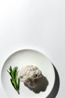 Raw cauliflower bouquet with rosemary from above with sunlight. Flat lay. Top view — Stock Photo