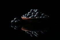 Fresh blueberries on wooden bowl on table — Stock Photo