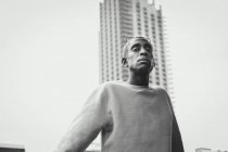 Trendy African American man walking on city street — Stock Photo