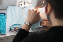 Женщина делает маски для пандемии коронавируса — стоковое фото