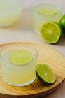 Homemade refreshing lemonade in glasses with fresh lime — Stock Photo