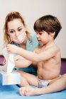 Little boy blowing nose in hospital on check up — Stock Photo