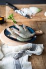 Big raw gray shrimps on big blue plate on cutting board — Stock Photo