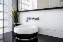 Large mirror placed over stylish counter with sink — Stock Photo