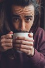 Bearded man resting with hot beverage — Stock Photo