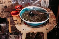 Big bowl of marinated olives while in local delicatessen rustic food store — Stock Photo
