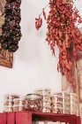 From below pieces of delicious dried meat hanging on ropes from ceiling in cozy local food store — Stock Photo