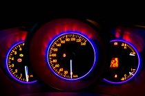 Car instrument panel with neon illumination on digital display with indicators and information about speed — Stock Photo
