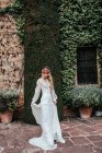 Young bride standing near old estate — Stock Photo