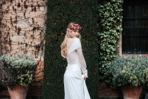 Young bride standing near old estate — Stock Photo