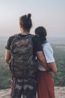 Back view of unrecognizable content couple of hipsters in casual clothing hugging traveling together around Sri Lanka enjoying majestic landscapes — Stock Photo
