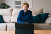Old woman communicating with daughter on video chat on laptop — Stock Photo