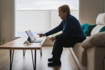 Старуха общается с дочерью в видеочате на ноутбуке — стоковое фото