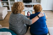 Women having video conversation on laptop at home — Stock Photo