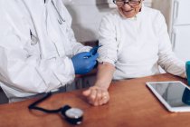 Caregiver making injection for senior patient at home — Stock Photo