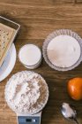 Top view of electronic scale with wheat flour and ingredients for delicious aromatic homemade muffins in kitchen — Stock Photo