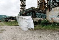 Прозрачный призрак рядом со старым заброшенным шахтным зданием с ржавыми металлическими конструкциями и обветшалыми стенами — стоковое фото