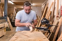 Handwerker polieren Holzdetails mit Schmirgelpapier in Tischlerei — Stockfoto