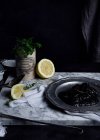 Metal plate with plum jelly placed on white fabric on table together with lime slices and bunch of parsley — Stock Photo