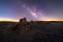 Majestic scenery of volcanic terrain with porous rocks and colorful Milky Way on background — Stock Photo