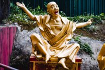 Падение золотой статуи Будды на стул в светлом саду Десяти тысяч Будд в Гонконге — стоковое фото