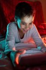 Delighted boy watching cartoon on tablet — Stock Photo