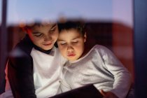 Cute brothers watching cartoon on tablet together — Stock Photo
