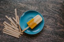 Top view of delicious fruit popsicle placed on table with wooden sticks — Stock Photo