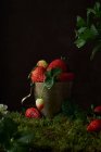 Composition with fresh ripe red strawberries with mint leaves placed in metal bowl on dark background — Stock Photo