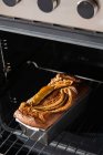 From above healthy banana bread in container in oven — Stock Photo