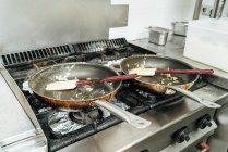De cima panelas sujas vazias depois de preparar o prato no fogão na cozinha do restaurante — Fotografia de Stock