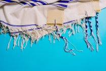Top view of shawl with striped ornament representing trip concept on bright background — Stock Photo