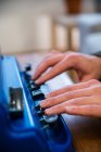Crop anonymous visually impaired male typing on typewriter with tactile writing system at home — Stock Photo