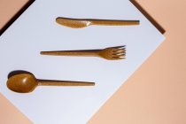 Overhead view of brown eco friendly cutlery on pastel background — Stock Photo