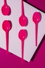 From above view of bright pink eco friendly spoon on pink carton background — Stock Photo