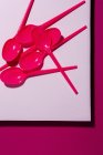 From above view of bright pink eco friendly spoon on pink carton background — Stock Photo