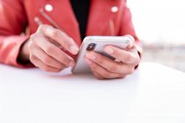 Руки черной женщины с помощью мобильного телефона — стоковое фото