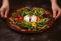 Yummy burrata cheese on cold tomato cream with arugula leaves and cherry tomatoes with truffles and peanuts — Stock Photo