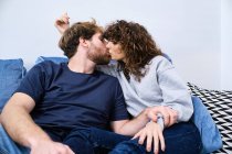 Young man and woman kissing and hugging each other while spending romantic day together — Stock Photo