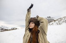 Young mindful female tourist with closed eyes breathing against mount during trip in Asturias in winter — Stock Photo