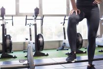 Crop anonimo atleta femminile sollevamento bilanciere pesante durante un intenso allenamento funzionale in palestra con attrezzature moderne — Foto stock