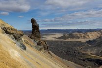 Spectacular landscape of endless rough rocky terrain with dry slopes and random vegetation located under clear blue sky in Iceland — Stock Photo